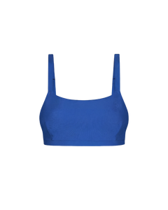 Royal blue cropped top with textured fabric and wide shoulder straps, front view, minimalist design