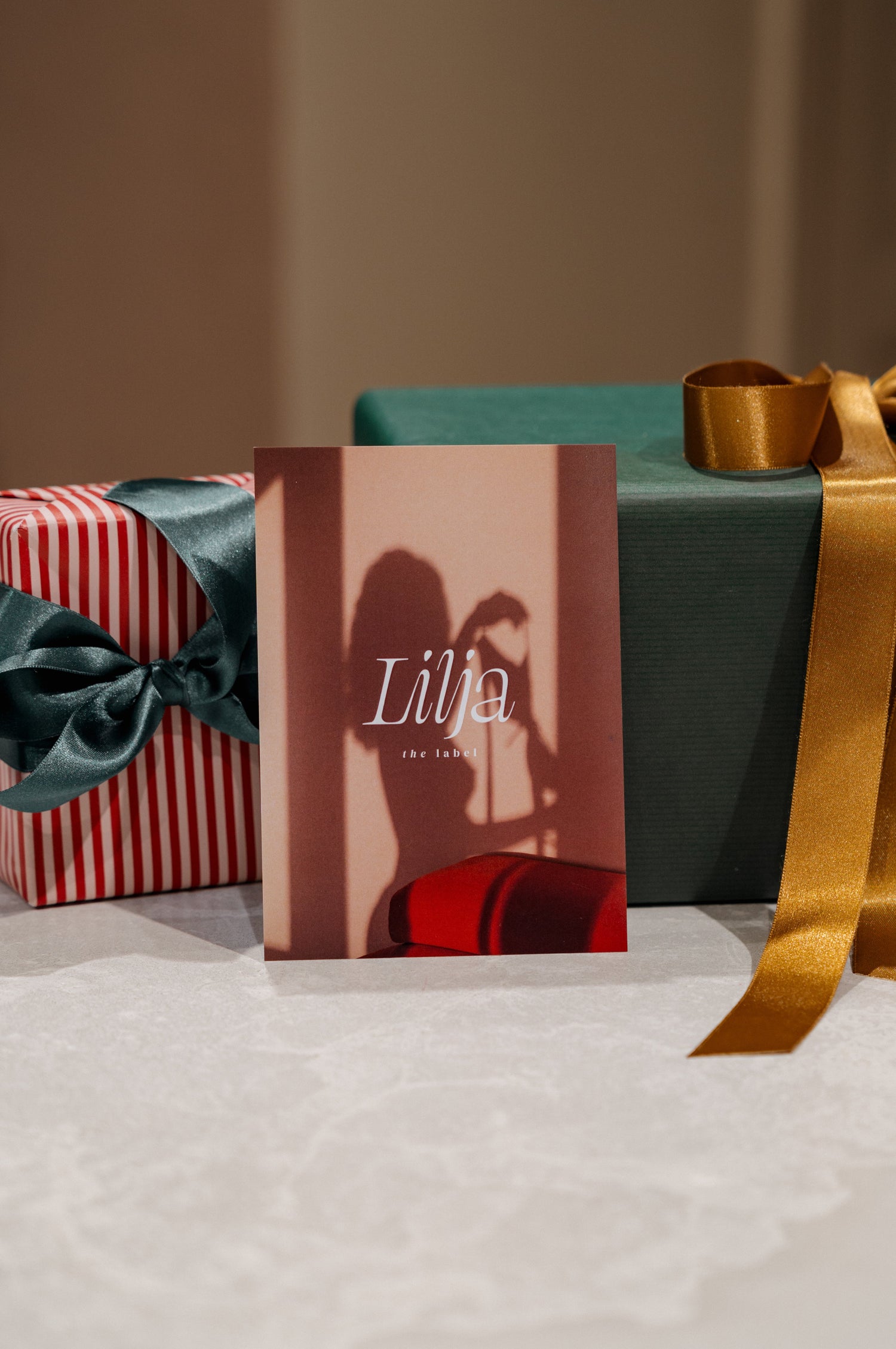 Gift card by Lilja the Label with a shadow of a person in an indoor setting.