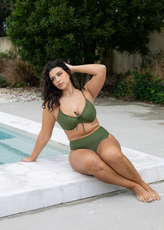 Olive drawstring top by Lilja the Label, worn with matching high-waisted bikini bottoms, while posing near a pool.
