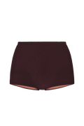 Sienna mini shorts in deep burgundy ribbed knit, front view with elastic waistband and exposed peach lining at hem.