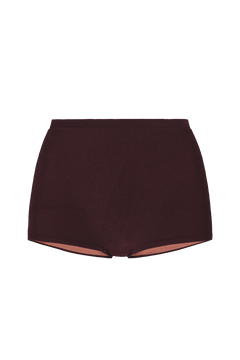 Sienna mini shorts in deep burgundy ribbed knit, front view with elastic waistband and exposed peach lining at hem.